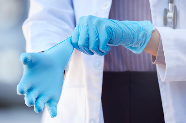doctor putting on nitrile gloves